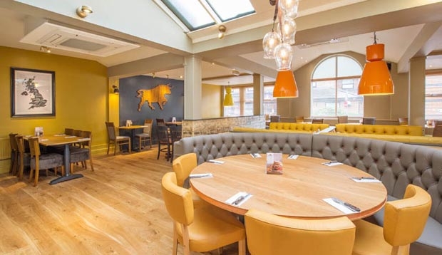 Large table with booth seating inside Beefeater restaurant, next to our Cannock South hotel.