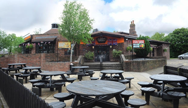 Picnic bench seating for restaurant outside Premier Inn Carlisle Central hotel