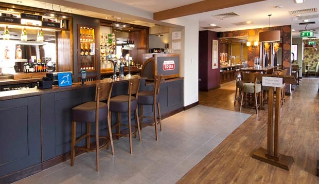 Bar area with restaurant seating in the background at Premier Inn Coventry City Centre hotel