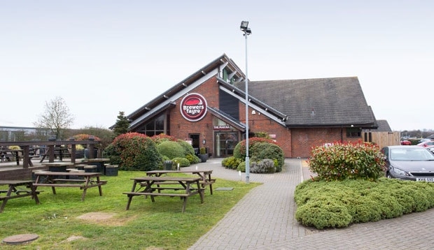 Surrounding area at Premier Inn Hinckley showing picnic benches and restaurant exterior