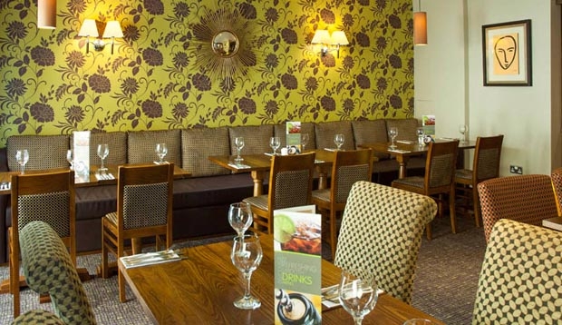Restaurant area at Premier Inn London Southwark (Tate Modern) hotel with wine glasses set out