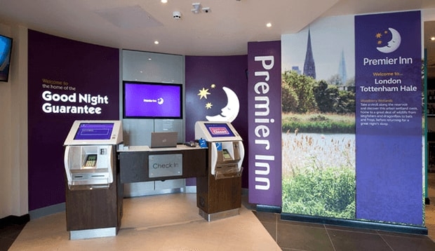 Reception area with self check-in kiosks at Premier Inn Tottenham hotel