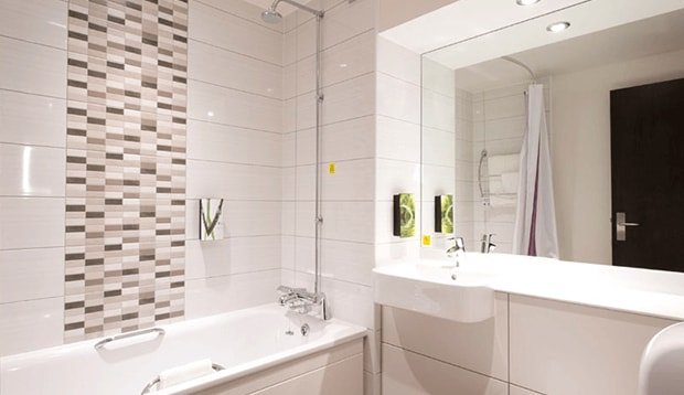 Standard bathroom with shower over bath at Tottenham Hale hotel
