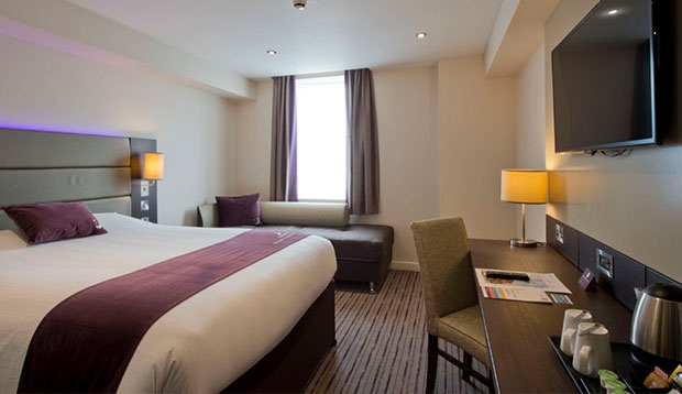 Bedroom with king size bed, sofa, desk and 40
