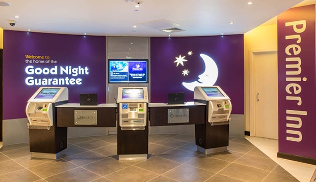 Reception with self check-in machines in Manchester hotel