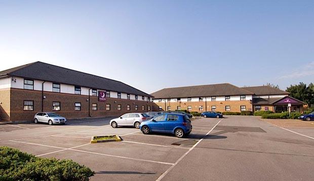 Exterior of Premier Inn Hotel Cardiff City South showing car park