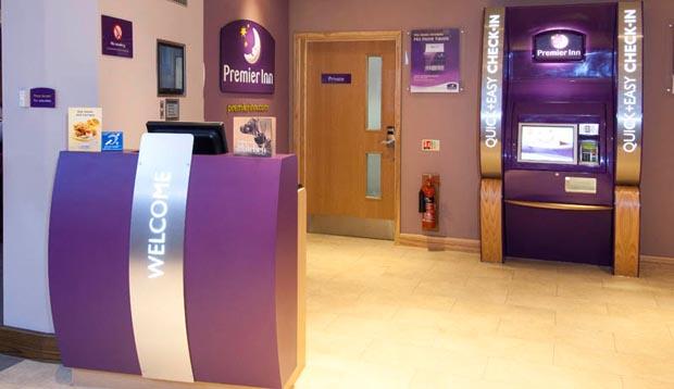 Reception area at Premier Inn Kidderminster showing check in desk and self service kiosk