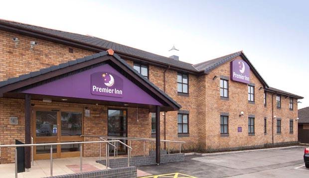 Exterior at Premier Inn Llanelli Central West hotel showing car park area