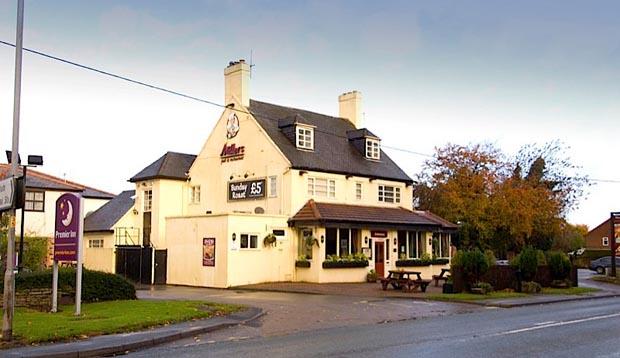 Exterior of Premier Inn Macclesfield South hotel with street view