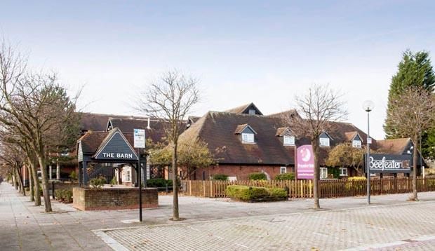 Exterior at Premier Inn Milton Keynes Central hotel showing street and exterior of restaurant