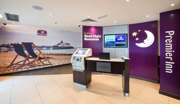 Reception area with self check-in kiosks at Premier Inn Eastbourne