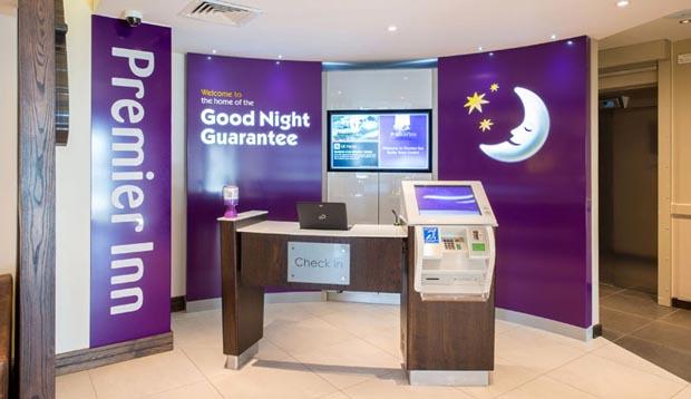 Reception at Premier Inn Tenby Town Centre showing self check in kiosks