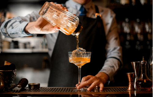Barmann bereitet Cocktail zu
