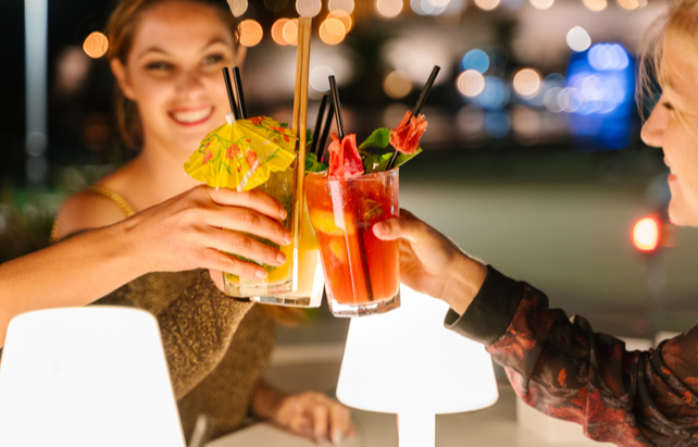 Freundinnen stoßen mit Cocktails an