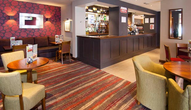 Bar area with seating inside Premier Inn Camberley hotel
