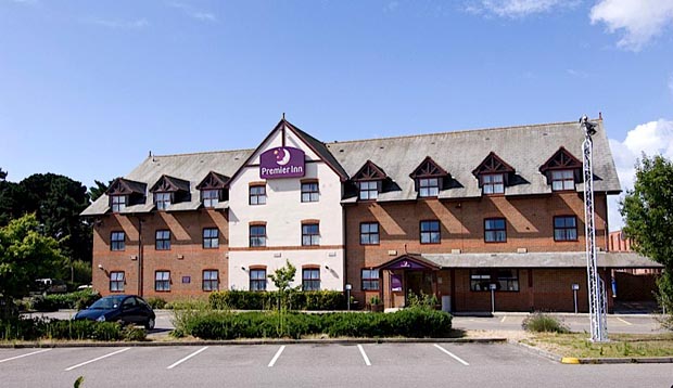 Exterior of Premier Inn Hotel Christchurch West with car park visible