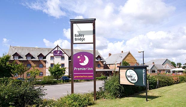 Outside of Premier Inn Hotel Christchurch West with Table Table sign