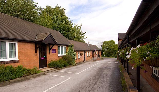 Exterior of Premier Inn Derby North West with car park