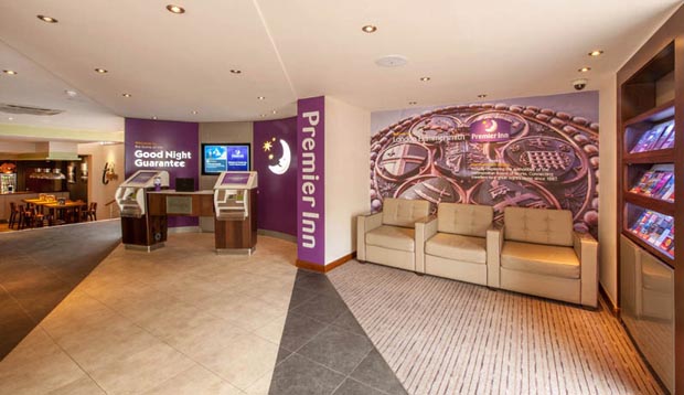 Reception at London Hammersmith hotel showing seating area and self check-in