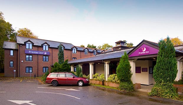 Exterior at Premier Inn Manchester (Wilmslow) hotel showing car park and reception