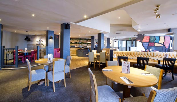 Restaurant tables at Premier Inn Manchester Airport (Heald Green) hotel