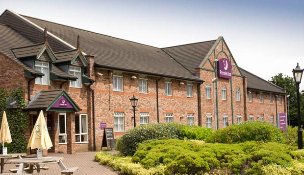 Exterior at Premier Inn Manchester (Sale) hotel showing surrounding gardens and restaurant area