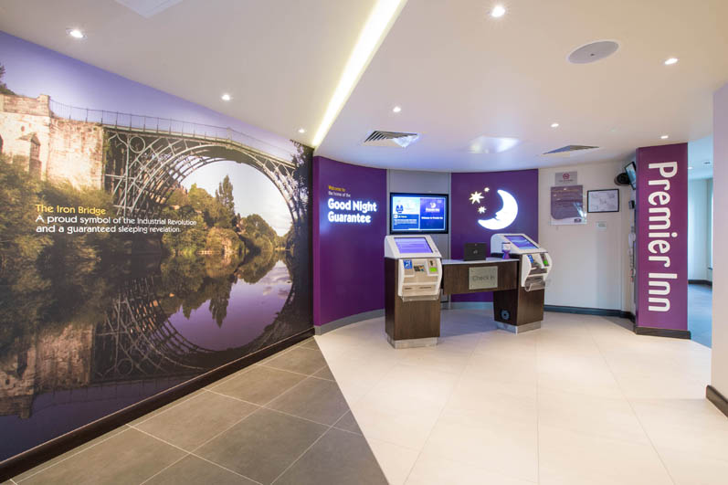 Reception at Telford International Centre showing self check in kiosks